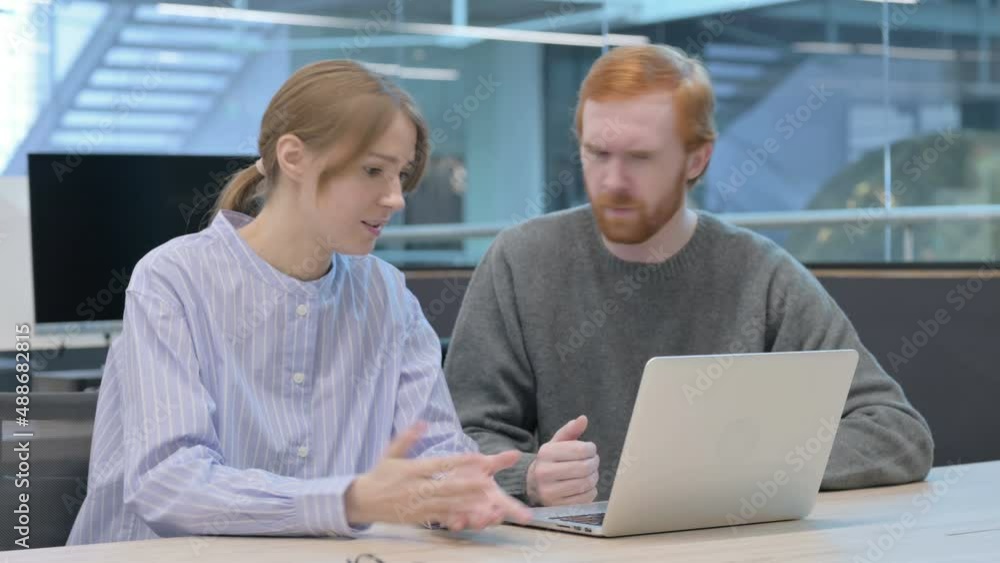 Young Man and Woman Reacting to Loss on Laptop Young Man and Woman Reacting to Loss on Laptop