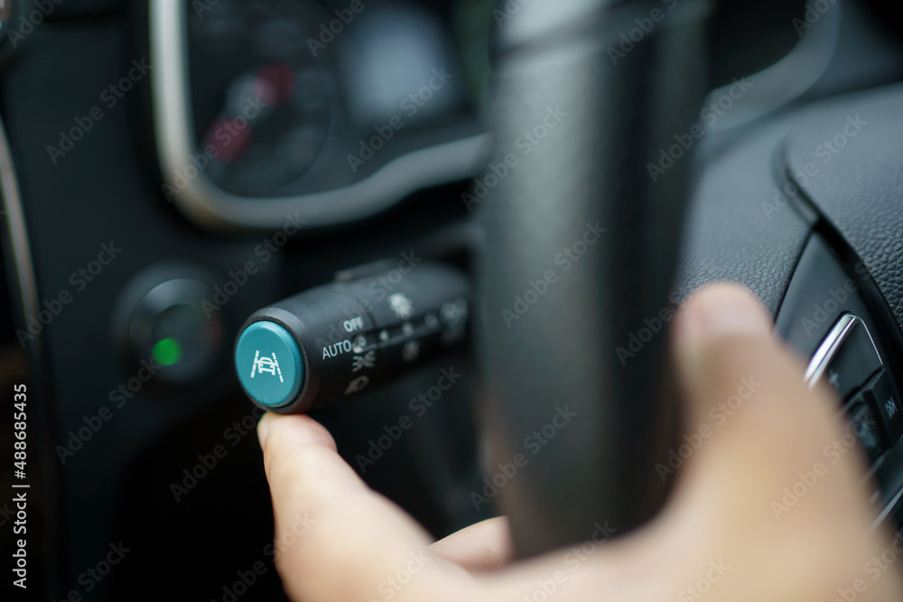 Unrecognizable man driver activating the adaptive cruise control or steering assistant on the control stick. Unrecognizable man driver activating the adaptive cruise control or steering assistant on the control stick.