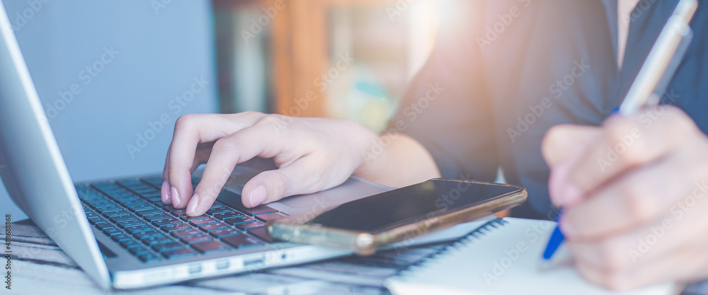 Woman hand use a laptop computer in the office.