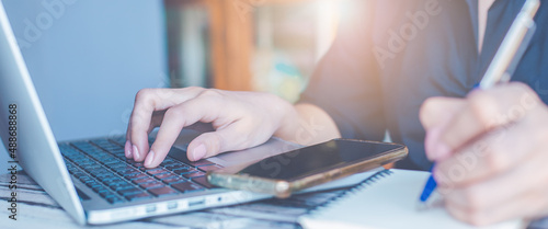 Woman hand use a laptop computer in the office.