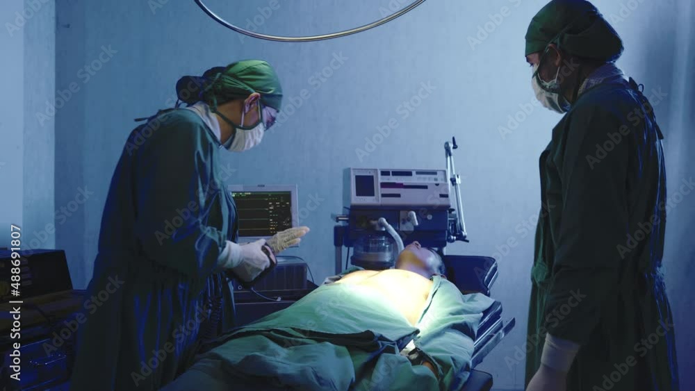 Defibrillation cardiac dysrhythmia, Surgical doctor team performing surgery patient on operating