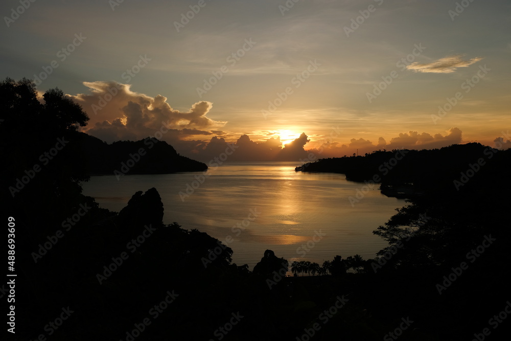 A stunning golden glowing sunrise overlooking Pokpok Island, Kieta and gorgeous ocean view in the Autonomous Region of Bougainville, Papua New Guinea