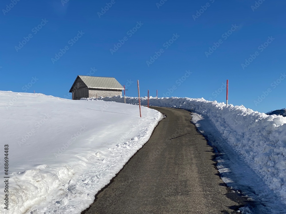 Winter snow idyll along the rural alpine road above the Obertoggenburg valley and on the slopes of the Alpstein mountain range - Alt St. Johann, Switzerland (Schweiz)