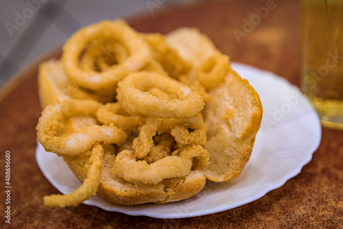 Spanish fried calamari sandwich and apple cider in a restaurant in Madrid, Spain