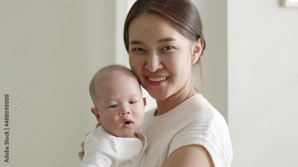 Portrait smiling Asian mother with her newborn baby Portrait smiling Asian mother with her newborn baby