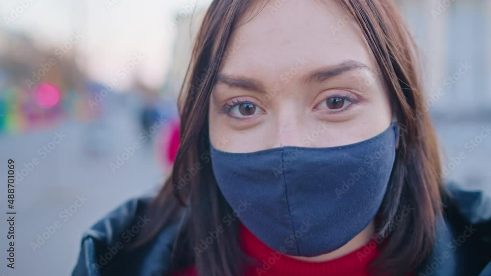 a young woman in a medical mask stands on the street. close-up. quarantine period. anti-covid measures. a young woman in a medical mask stands on the street. close-up. quarantine period. anti-covid measures.