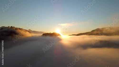 Wallpaper Mural Normal drone footage in Bled Slovenia captured at sunrise with in the nature with beautiful mountains and landscapes cover in fog and nice golden hour colors filmed in  dynamic movement from above Torontodigital.ca