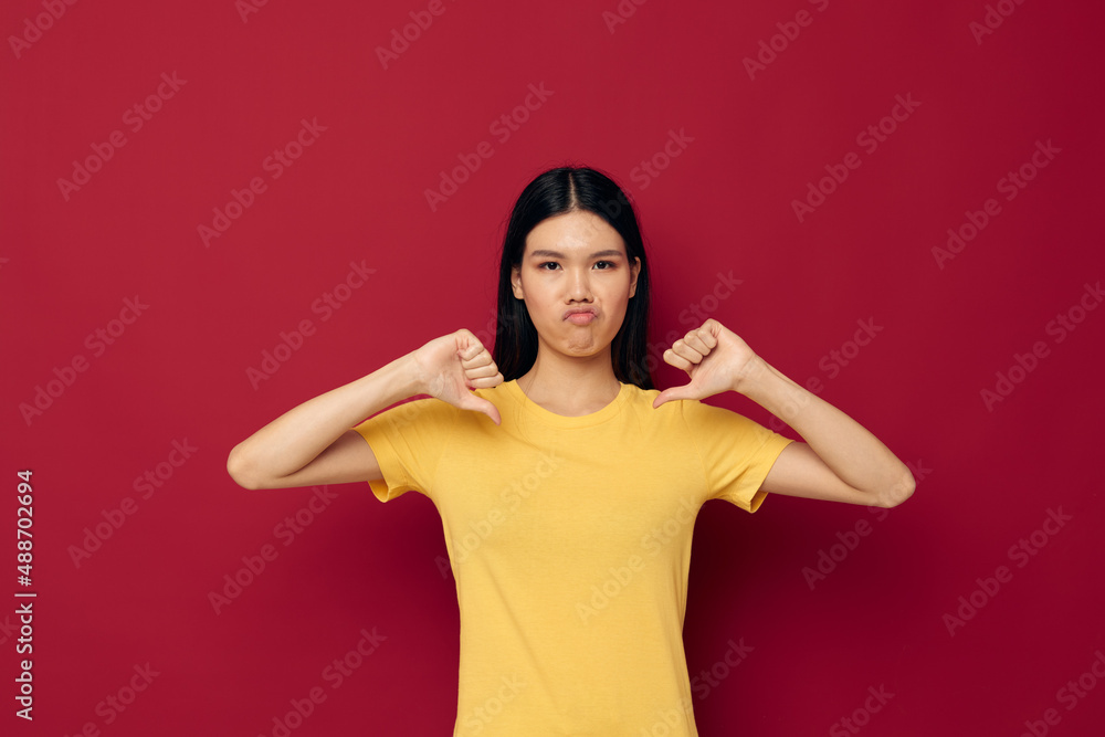 woman in a yellow t-shirt gesturing with his hands fun isolated background unaltered woman in a yellow t-shirt gesturing with his hands fun isolated background unaltered