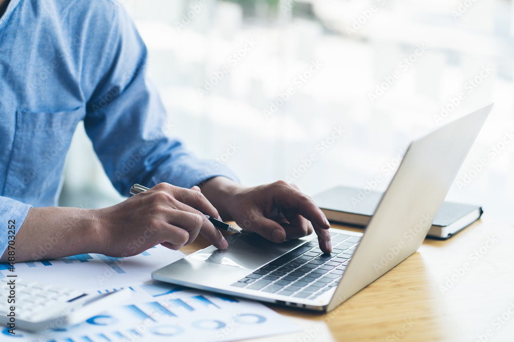 Close-up of a man hand pressing on the laptop keyboard, World of technology and internet communication, Financial professionals use laptop to calculate and check real estate earnings. Close-up of a man hand pressing on the laptop keyboard, World of technology and internet communication, Financial professionals use laptop to calculate and check real estate earnings.