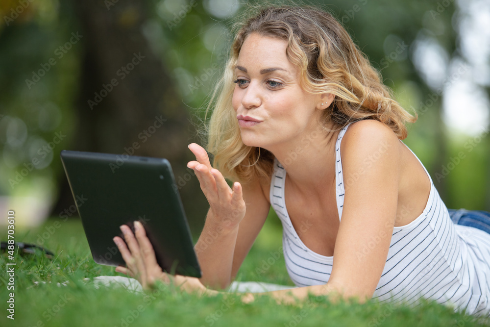 young woman with tablet on the grass young woman with tablet on the grass