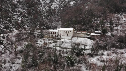 AERIAL - Village of Virpazar in snowy winter, mountains, Bar, Montenegro, reverse photo