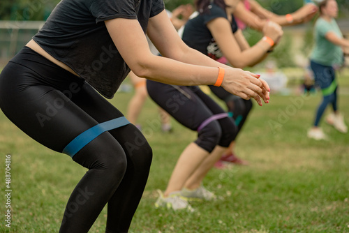 Closeup photo of sporty slim girls training with elastic band outdoor © Denys Kurbatov
