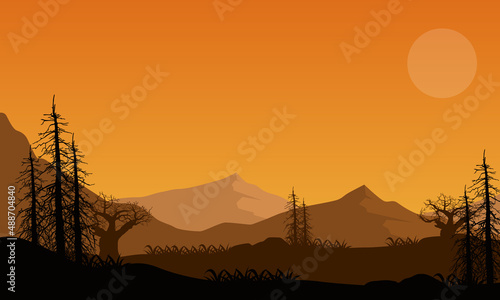 Beautiful mountain view from out of the city with the silhouette of dry trees around it