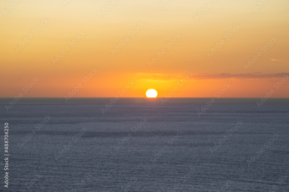 The sun is above the horizon during sunset at sea The sun is above the horizon during sunset at sea