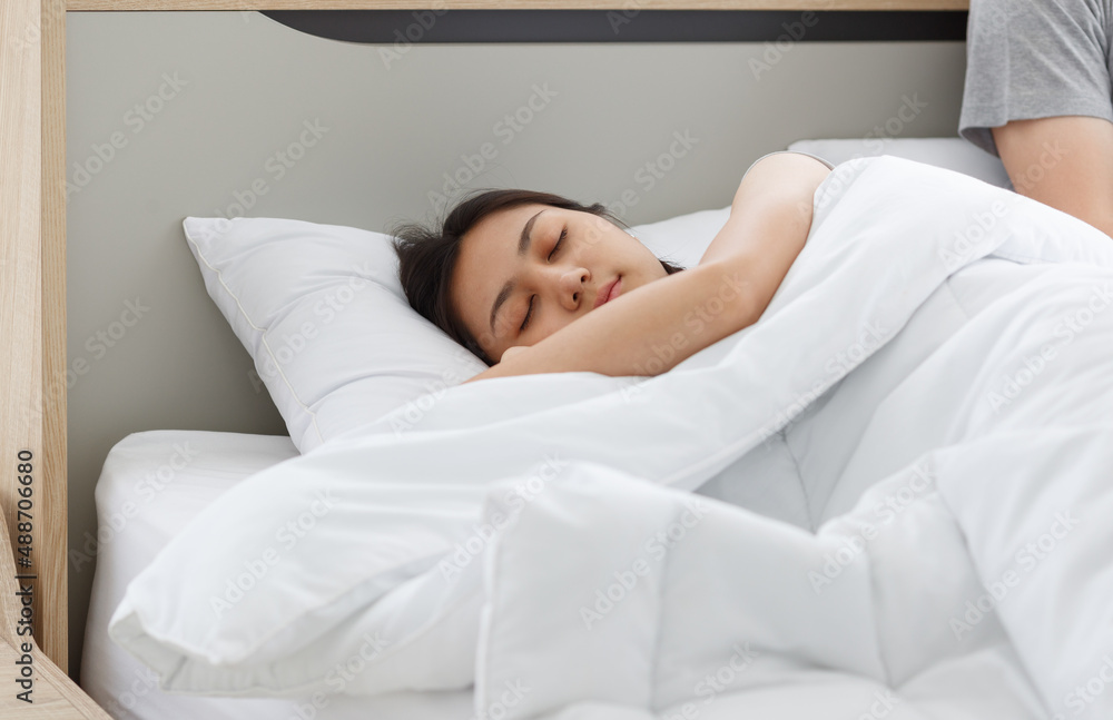 Closeup shot of Asian tired exhausted relaxing resting sleepy female housewife laying down on pillow cover with white soft blanket sleeping has sweet dream on bed in bedroom beside male husband Closeup shot of Asian tired exhausted relaxing resting sleepy female housewife laying down on pillow cover with white soft blanket sleeping has sweet dream on bed in bedroom beside male husband