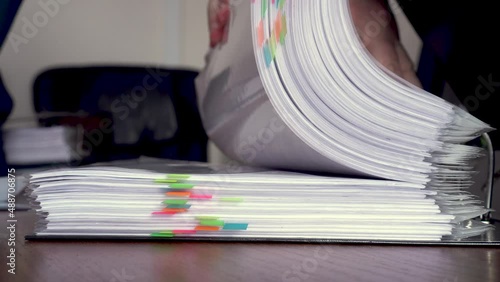 folder with documents with bright stickers. selective focus. Turning pages. Work in the office.