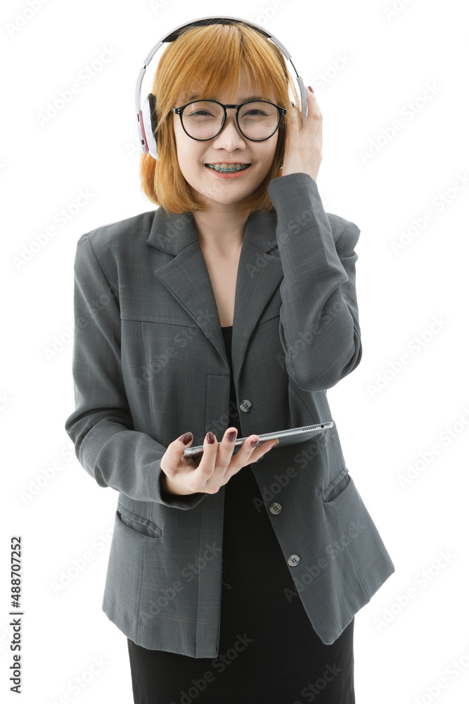 Isolated closeup cutout studio shot Asian young university female student in uniform and eyeglasses standing smiling holding headphone closed eyes listening to music song playlist on white background Isolated closeup cutout studio shot Asian young university female student in uniform and eyeglasses standing smiling holding headphone closed eyes listening to music song playlist on white background