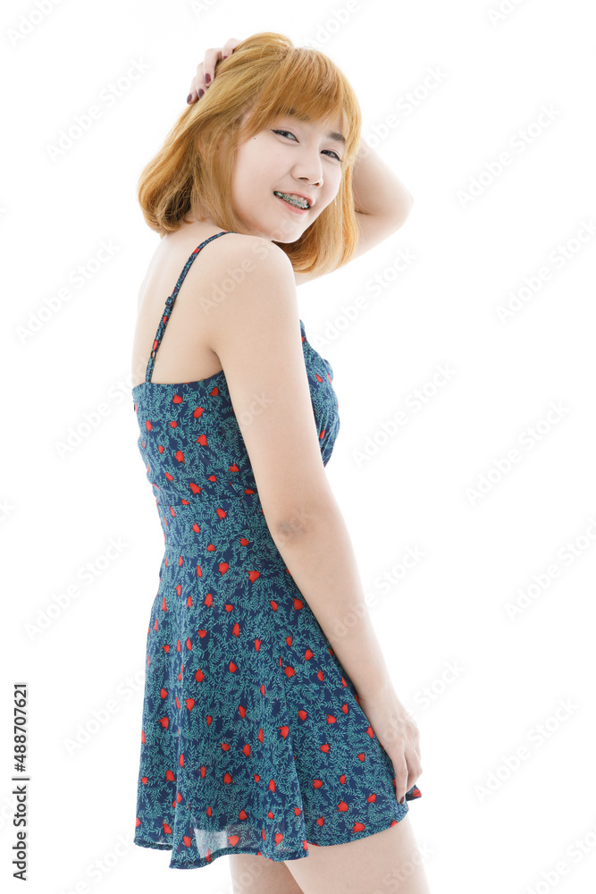 Isolated cutout studio full body shot of Asian young sexy blonde short hair female fashion model in camisole dress and sneakers standing look at camera on white background