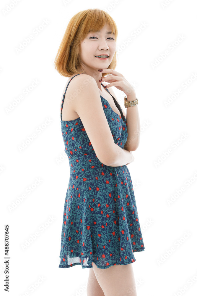 Isolated cutout studio full body shot of Asian young sexy blonde short hair female fashion model in camisole dress and sneakers standing holding hand touching lips crossed arm on white background Isolated cutout studio full body shot of Asian young sexy blonde short hair female fashion model in camisole dress and sneakers standing holding hand touching lips crossed arm on white background