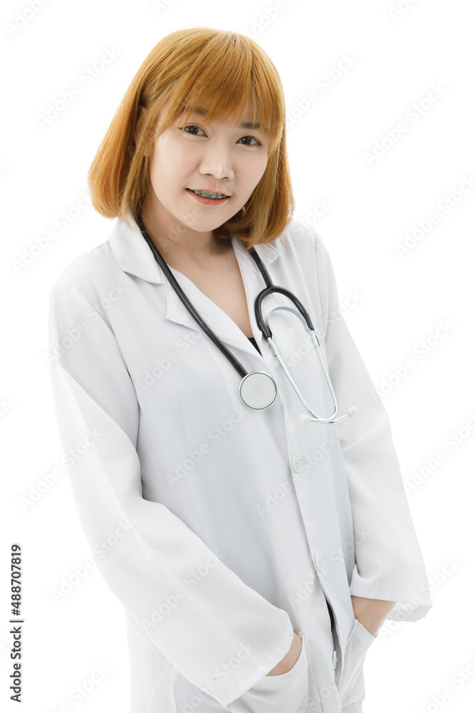 Portrait isolated cutout studio shot of Asian young blonde hair professional female doctor in lab coat with stethoscope standing smiling look at camera holding hands in pockets on white background Portrait isolated cutout studio shot of Asian young blonde hair professional female doctor in lab coat with stethoscope standing smiling look at camera holding hands in pockets on white background