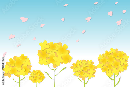 春の青空の下の菜の花と桜の花びら　ペーパークラフト風