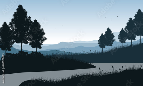 Panorama of mountains by the river in the morning with the silhouettes of pine trees around it