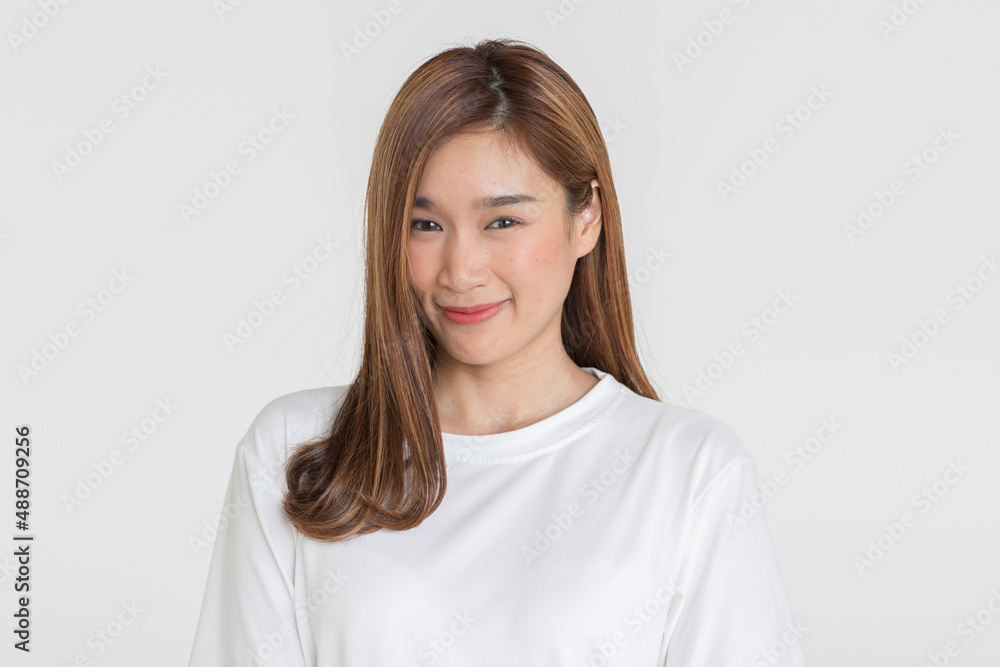 Portrait isolated cutout studio shot of Asian young happy cheerful long brown hair female teenager model in casual shirt standing smiling look at camera holding hand on elbow on white background Portrait isolated cutout studio shot of Asian young happy cheerful long brown hair female teenager model in casual shirt standing smiling look at camera holding hand on elbow on white background