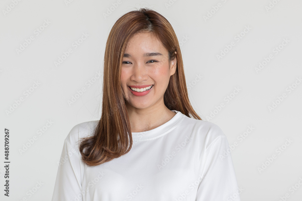 Portrait isolated cutout studio shot of Asian young happy cheerful long brown hair female teenager model in casual shirt standing smiling look at camera holding hand on elbow on white background Portrait isolated cutout studio shot of Asian young happy cheerful long brown hair female teenager model in casual shirt standing smiling look at camera holding hand on elbow on white background
