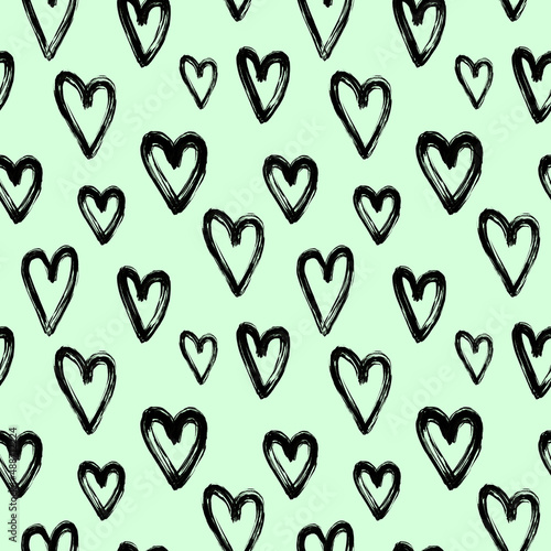 Black brush stroke hearts on pastel green background seamless pattern. Black paint heart repeat print. Valentine's day ornament for textile, fabric, wallpaper, wrapping paper, design and decoration.