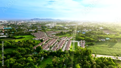 Aerial shot of housing project with high voltage electrical tower nearby