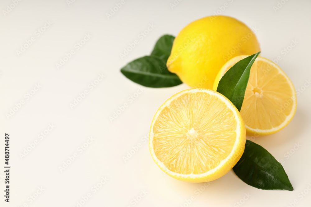 Lemons with leaves on white background, space for text