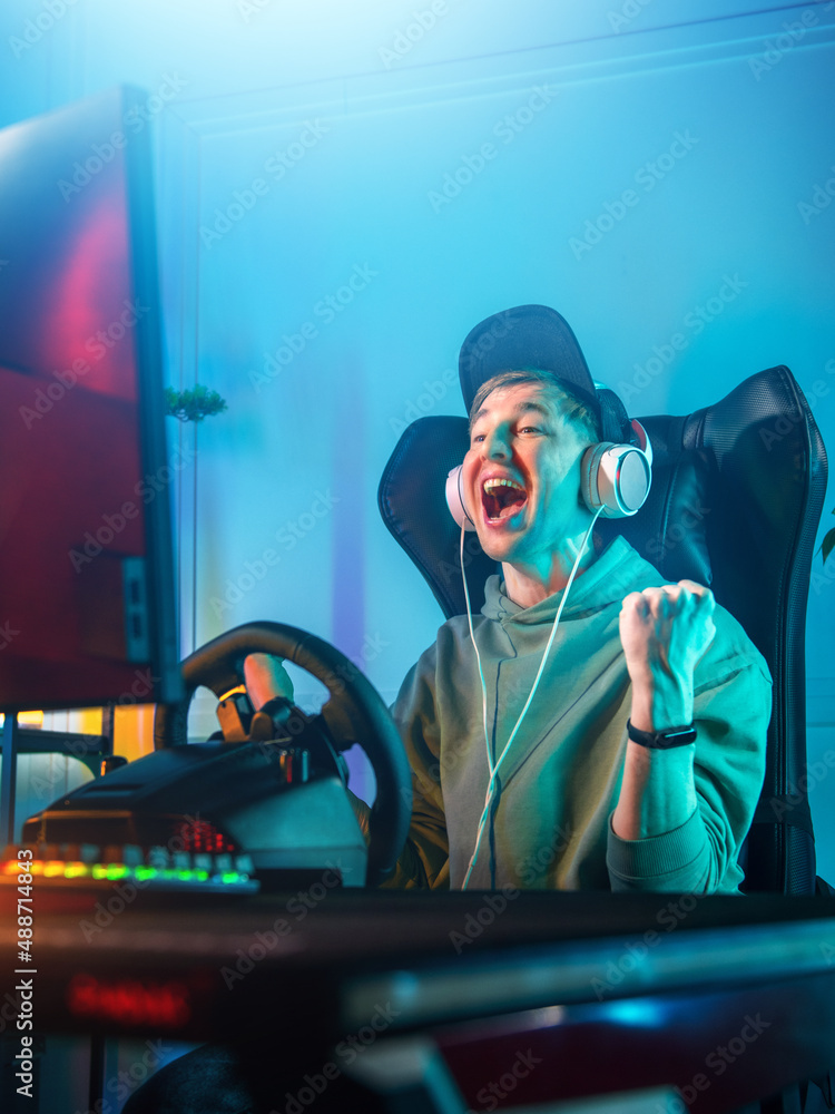 Pro Gamer Man Win Car Racing Online Video Game and Cheer Up with Fist Gesture