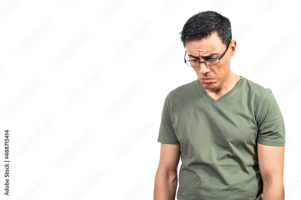 Upset male nerd in glasses looking down
