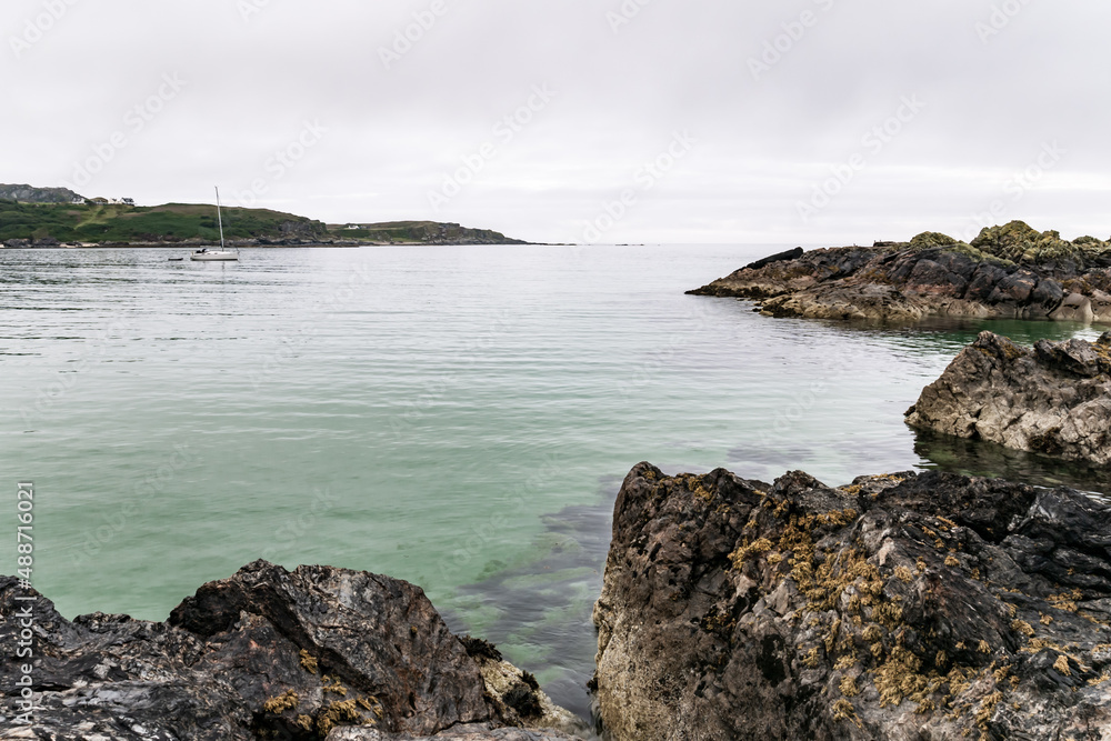 View of clear blue sea water over sharp rocks on the coast of the island of Colonsay in the Inner Hebrides