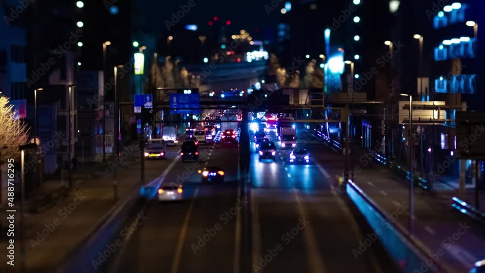 A night timelapse of the miniature traffic jam on the city street in Tokyo panning A night timelapse of the miniature traffic jam on the city street in Tokyo panning