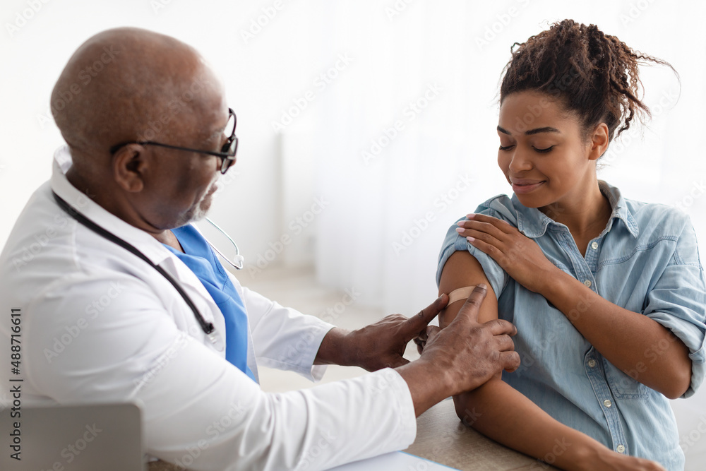 Pregnant Black Lady Getting Vaccinated, Doctor Applying Adhesive Bandage - obrazy, fototapety, plakaty 