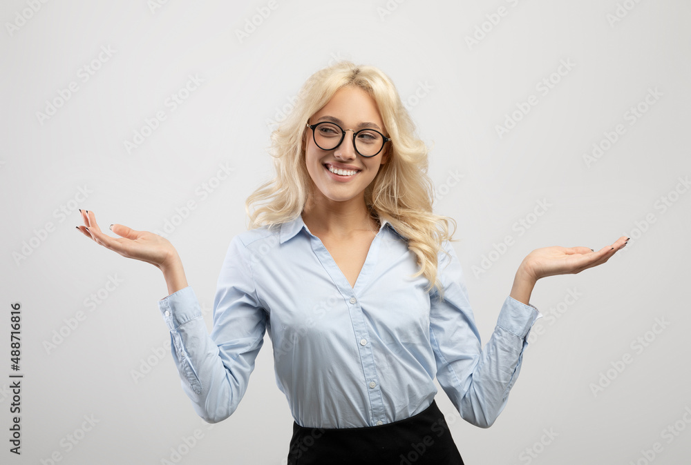 Positive woman in formal wear comparing options, making scales with her hands, holding invisible objects Positive woman in formal wear comparing options, making scales with her hands, holding invisible objects