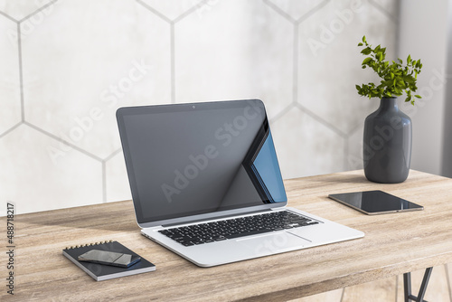 Close up of modern laptop near smartphone and digital tablet on wooden table surface in stylish home work place. 3D rendering