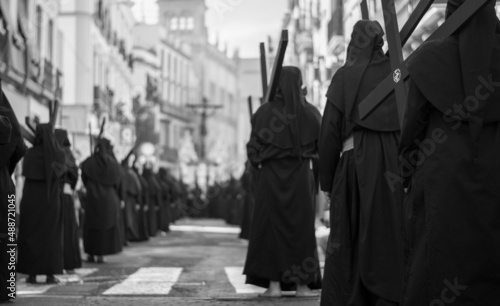 the penitents in  the processions march to Mount Calvary with the cross on his shoulders