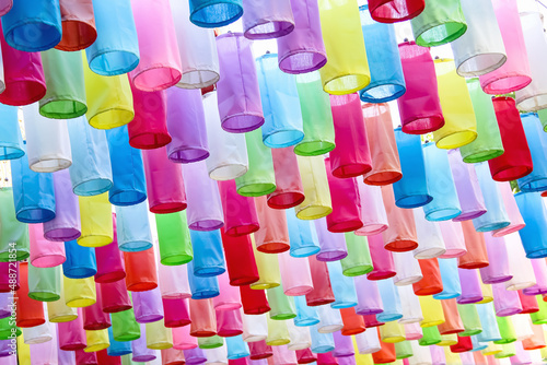 Many multicolored fabric lanterns hanging on line rope , decorative for celebration loy krathong festival or happy new year in temple , Chaing Mai of Thailand