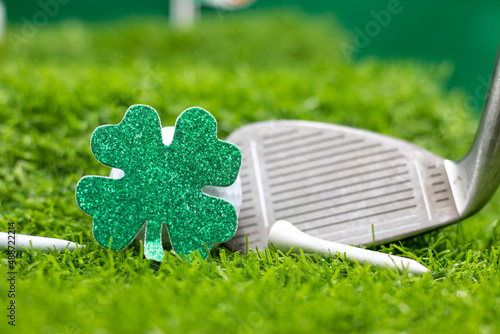 Golf ball for St. Patrick's Day on green grass. St. Patrick's Day is celebrated annually on March 17, the anniversary of his death in the fifth century. The Irish have observed this day as a religious