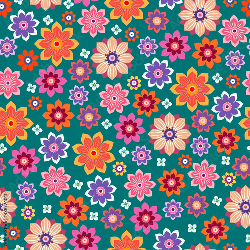 Floral seamless background. Various flowers and leaves on a green background.