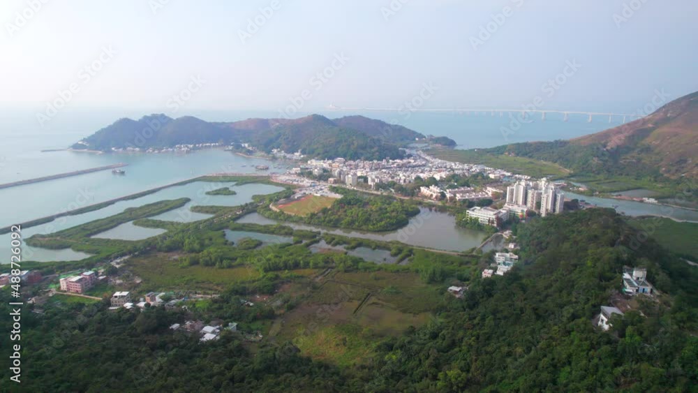 Famous tourist attraction in Hong Kong. aerial view of houses standing on the water in fishing village, Tai O, Lantau, Hong Kong, SAR of China. Daytime, clear autumn. Famous tourist attraction in Hong Kong. aerial view of houses standing on the water in fishing village, Tai O, Lantau, Hong Kong, SAR of China. Daytime, clear autumn.