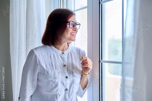 Business middle aged woman looking out the window.