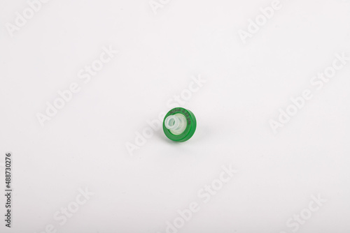 green needle tip filter standing on a white background. They are used in experiments in a laboratory environment.