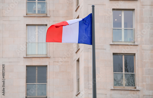 Flag of France winding over the buildings from Paris