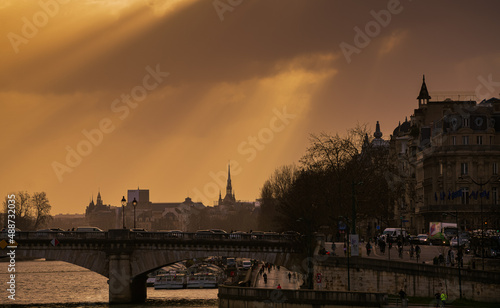Dramatic sunrise over the streets of Paris. Morning rush hour traffic on the boulevards next to Seine River. France  2022.