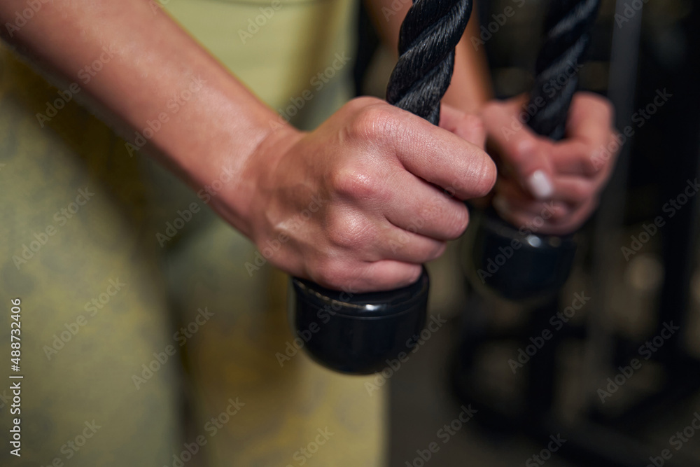 Focused photo on female hands holding rope