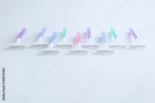 Set of multi-colored disposable razors on white background