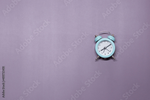 A small green alarm clock on a purple background shows 8 hours 10 minutes